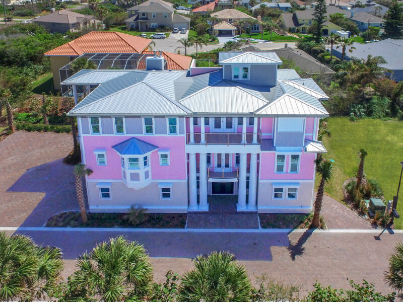 exterior of the vibrant pink three story Key West style Mallory home at Ponce Inlet Key