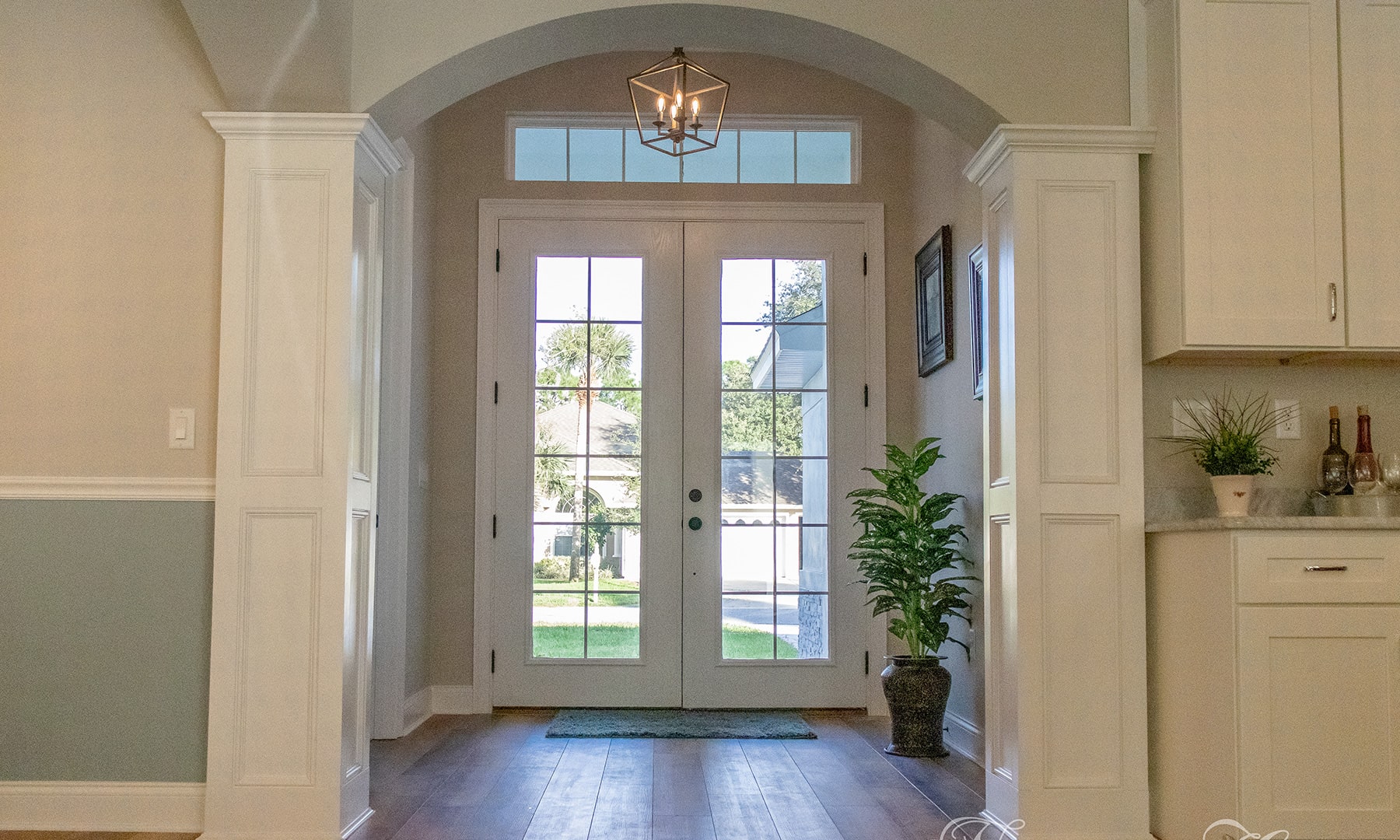 front entrance interior with arch entry from foyer to kitchen
